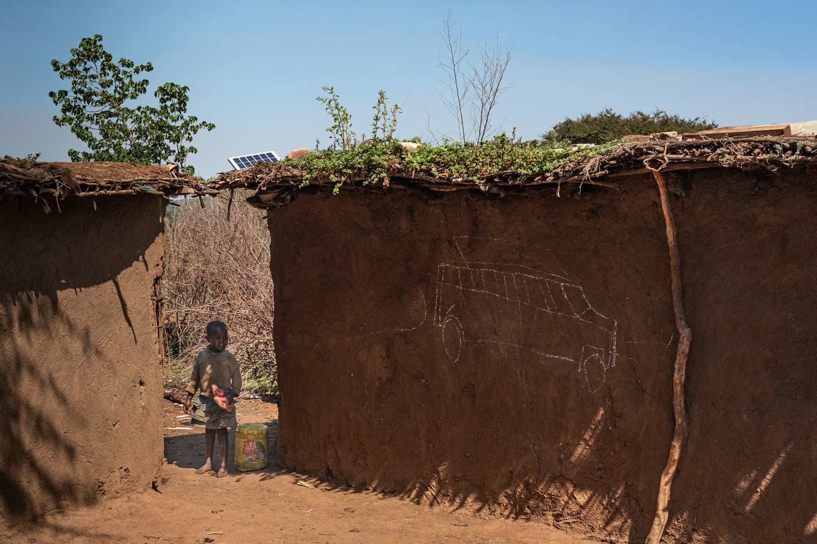 a man standing in front of a large rock